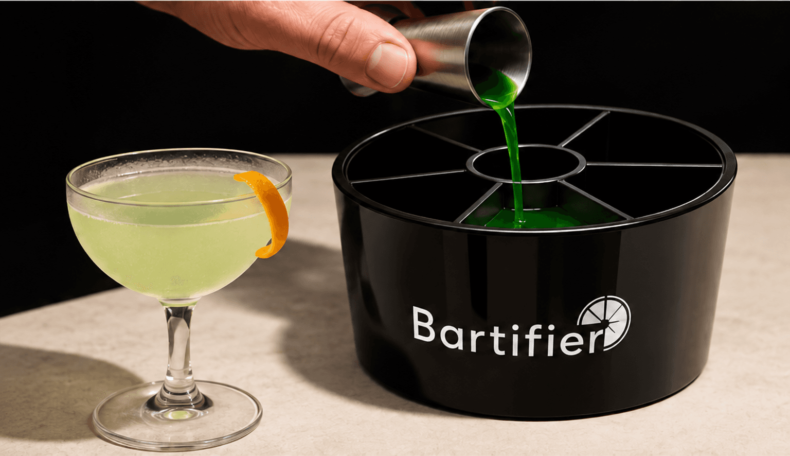 A green ingredient being measured into Bartifier beside a finished cocktail